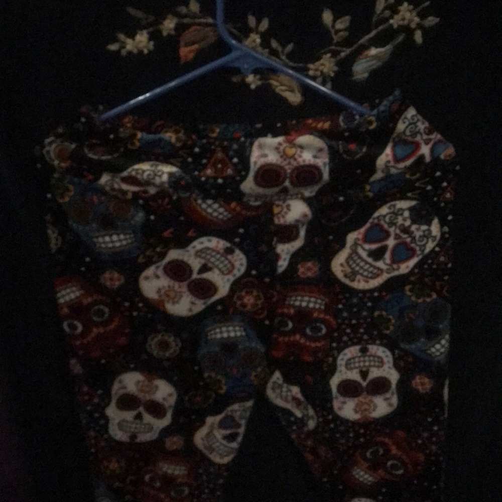 Soft black pants with candy skulls on them